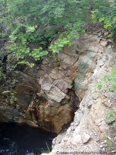 A quite uncommon zoned pegmatite (center of picture) carrying economic grades of Cu, Bi, Au and Ag. 